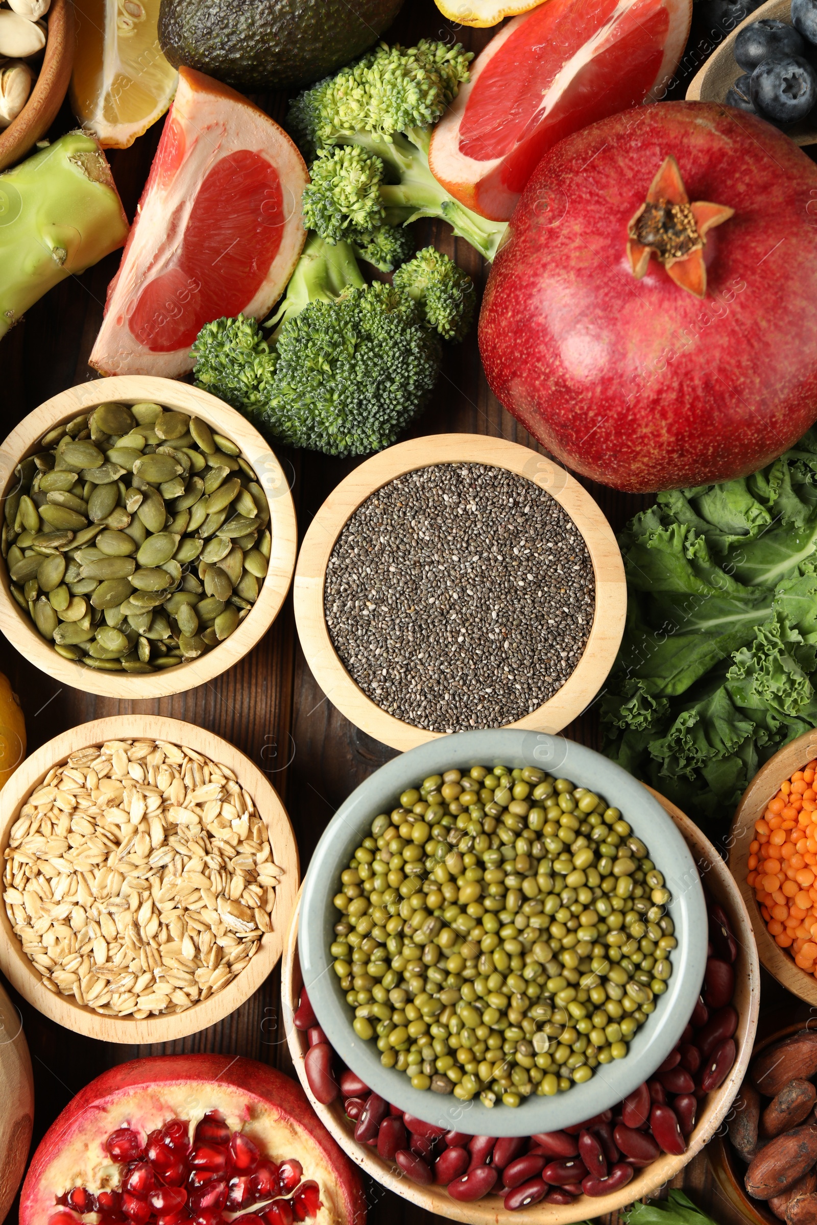 Photo of Different superfood products on wooden table, flat lay