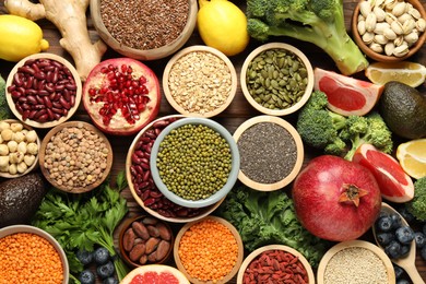 Photo of Different superfood products on wooden table, flat lay