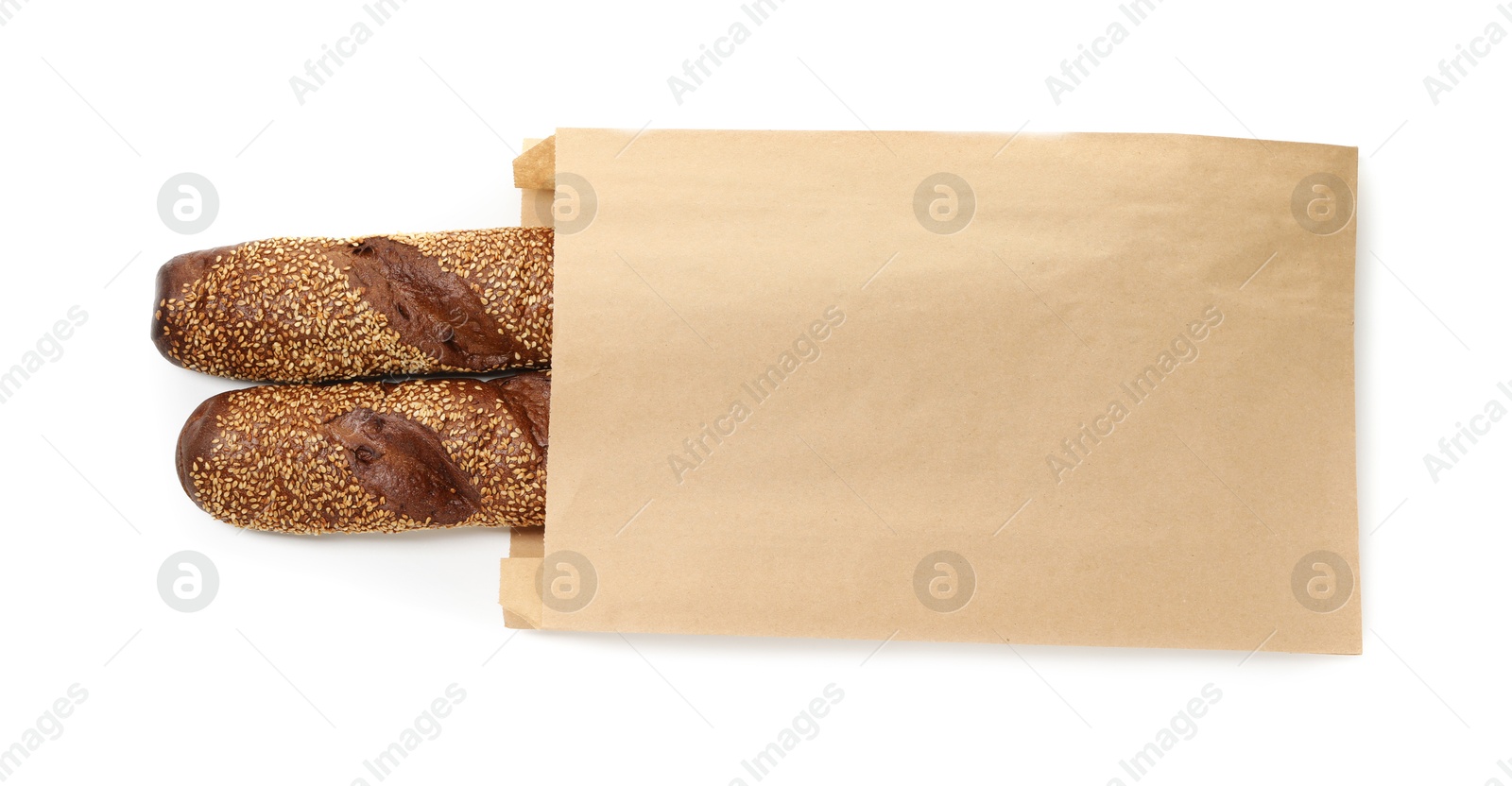 Photo of Fresh baguettes with sesame in paper bag isolated on white, top view