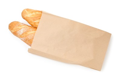 Photo of Freshly baked baguettes in paper bag isolated on white, top view