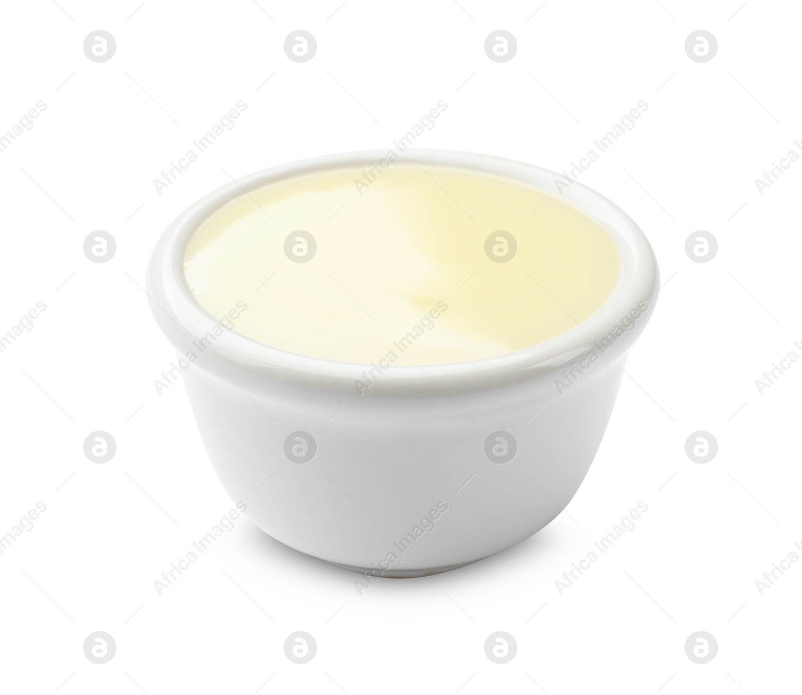 Photo of Condensed milk in bowl isolated on white