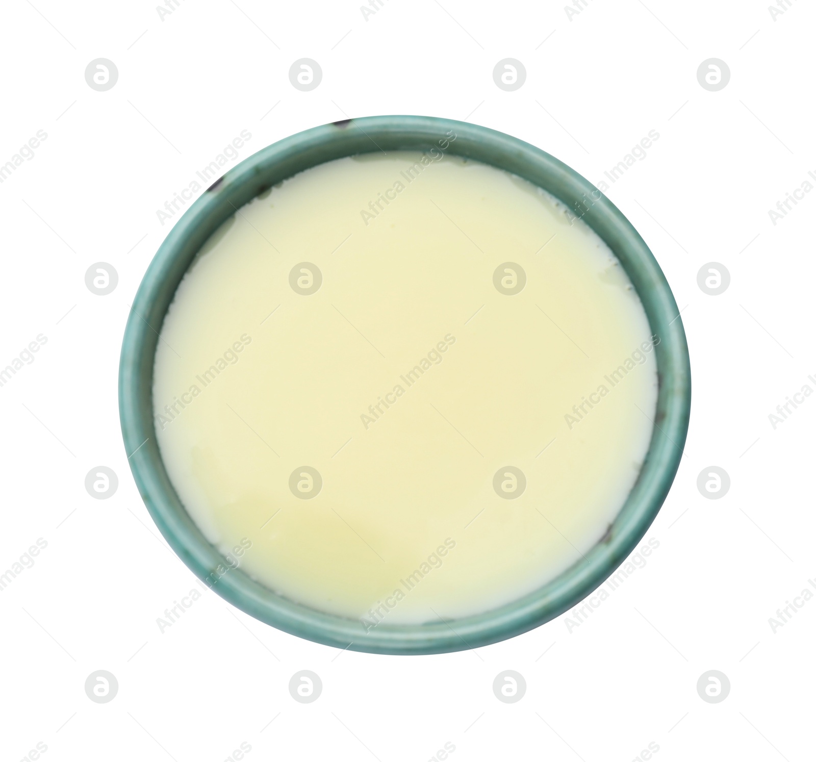 Photo of Condensed milk in bowl isolated on white, top view