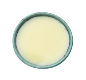 Photo of Condensed milk in bowl isolated on white, top view