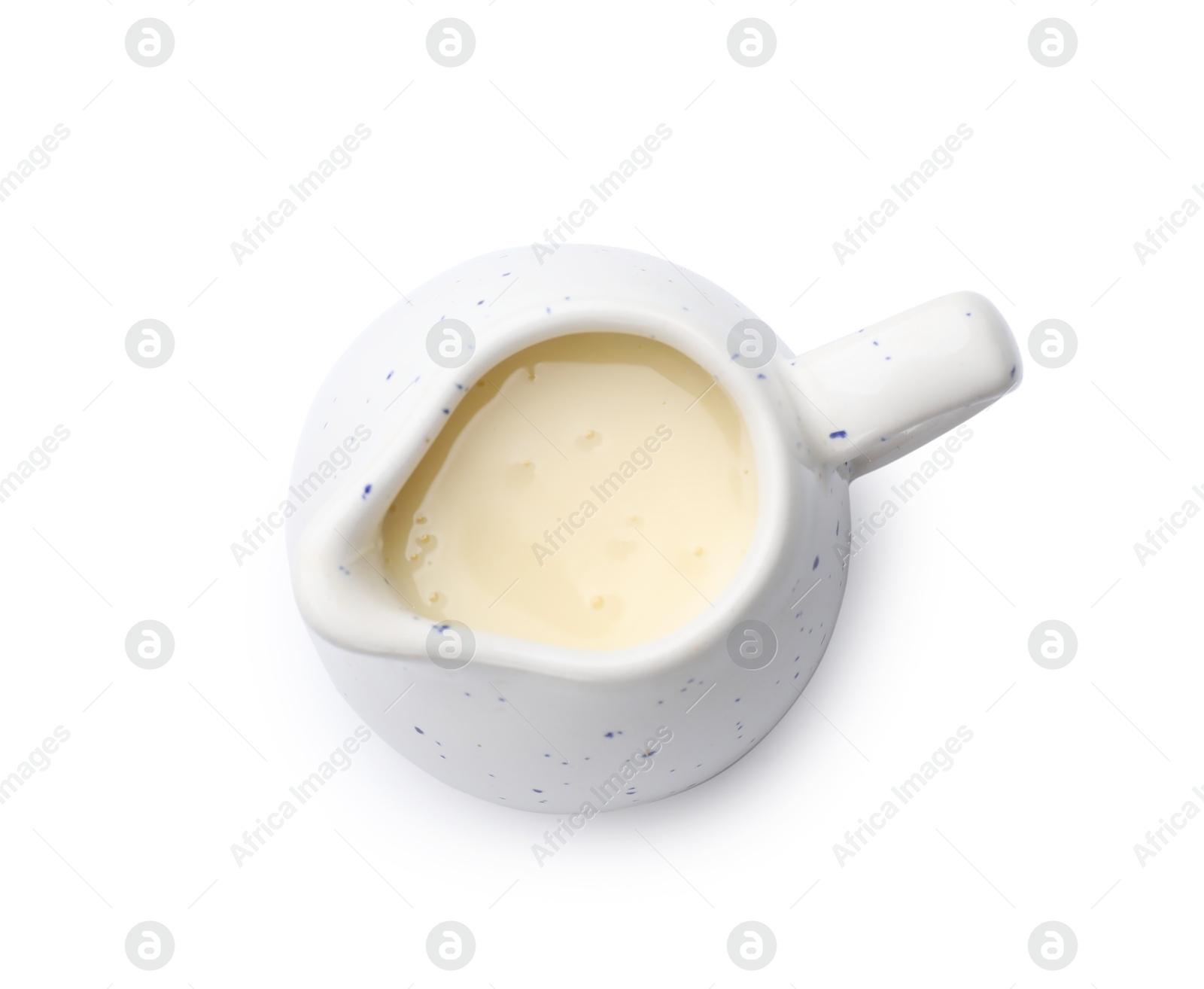 Photo of Condensed milk in jug isolated on white, top view