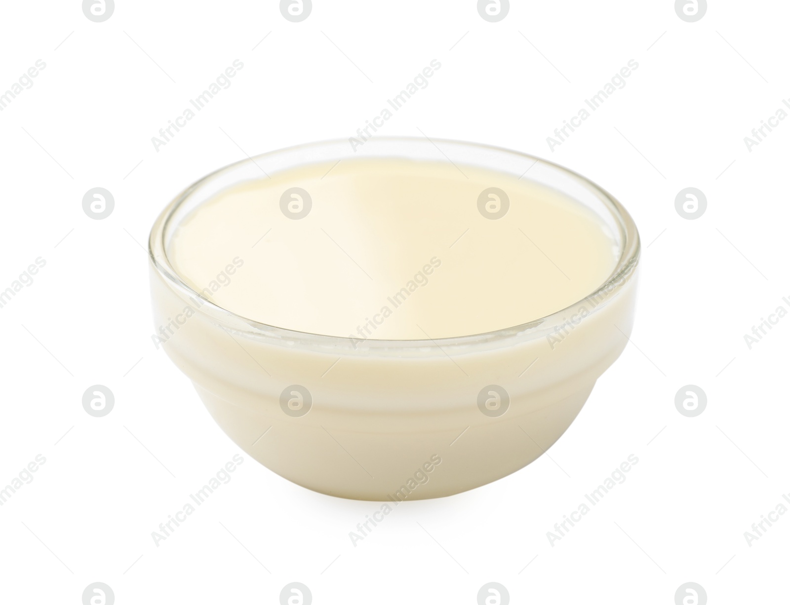 Photo of Condensed milk in bowl isolated on white