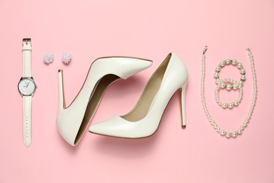 Photo of Many stylish jewelry, shoes and accessories on pink background, flat lay