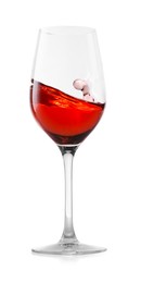 Photo of Rose wine splashing in glass on white background