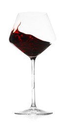 Photo of Red wine splashing in glass on white background