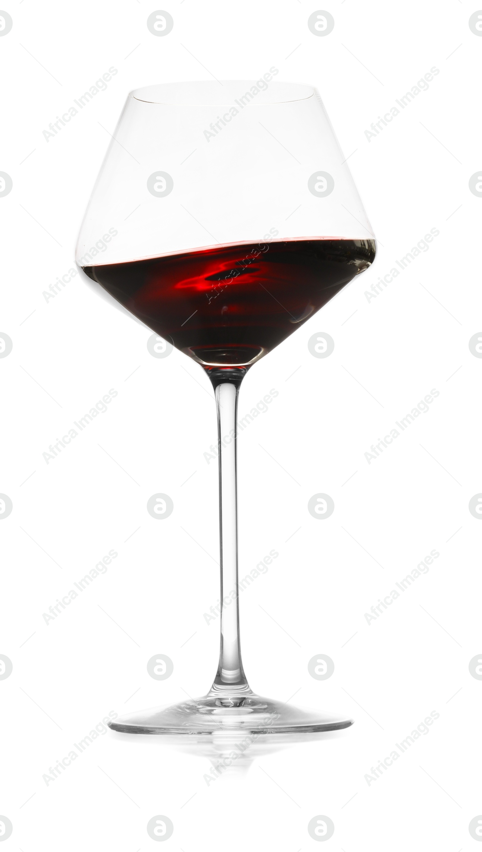 Photo of Red wine splashing in glass on white background