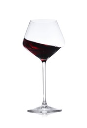 Photo of Red wine splashing in glass on white background