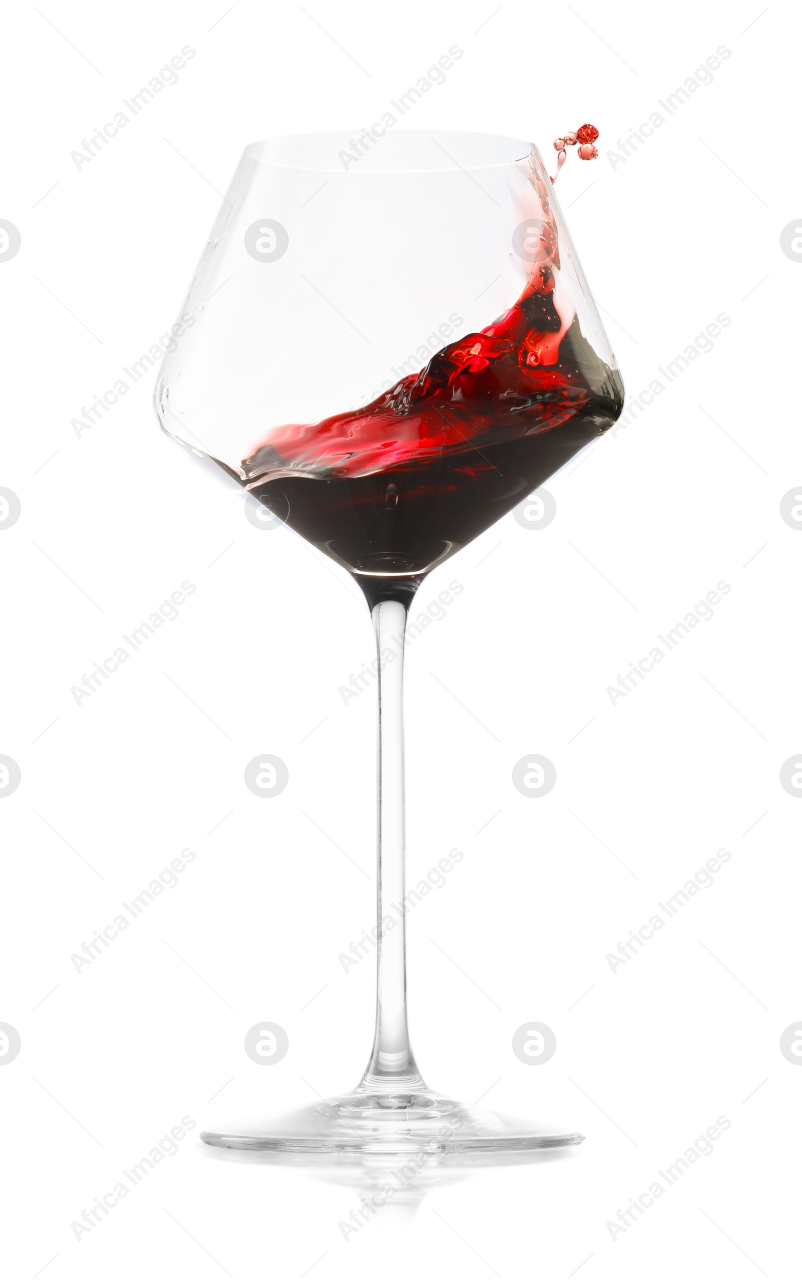 Photo of Red wine splashing in glass on white background