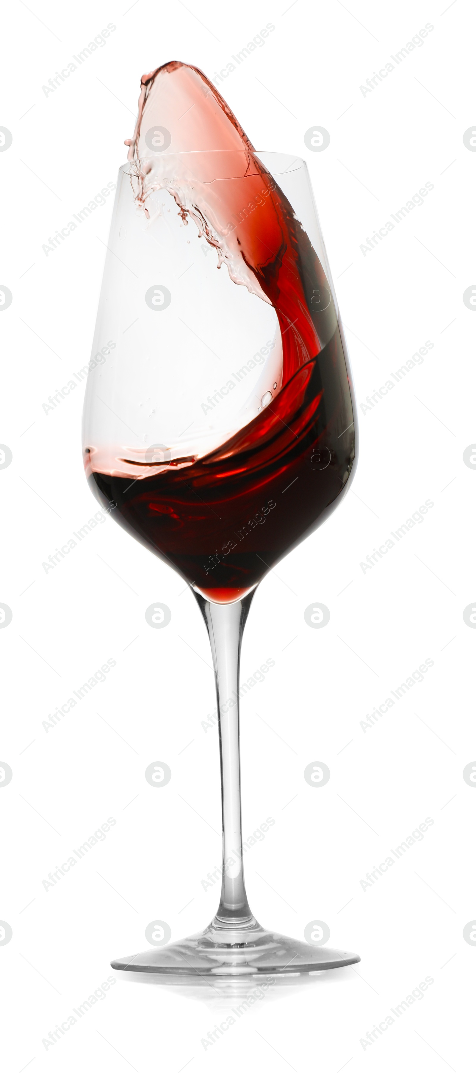 Photo of Red wine splashing in glass on white background