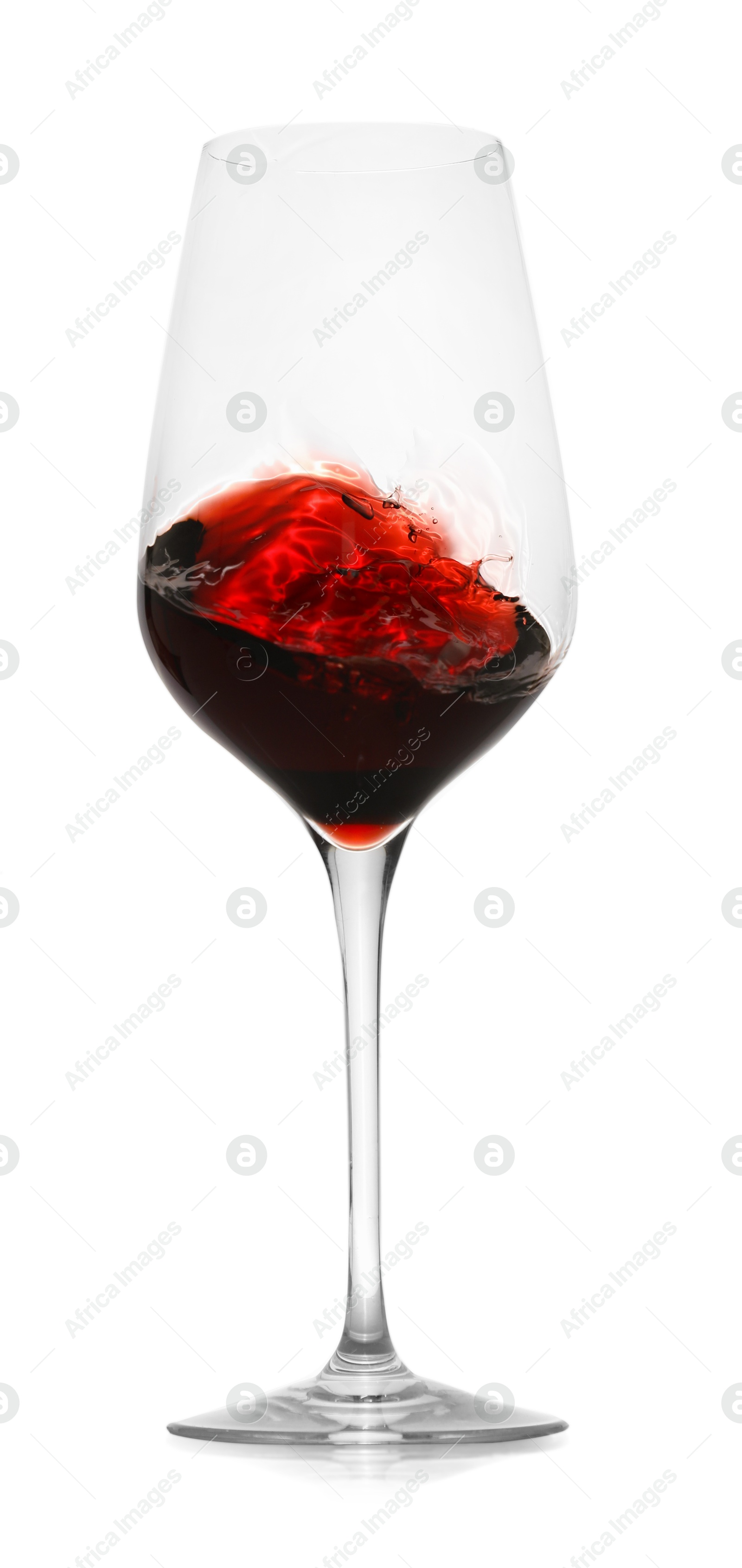 Photo of Red wine splashing in glass on white background