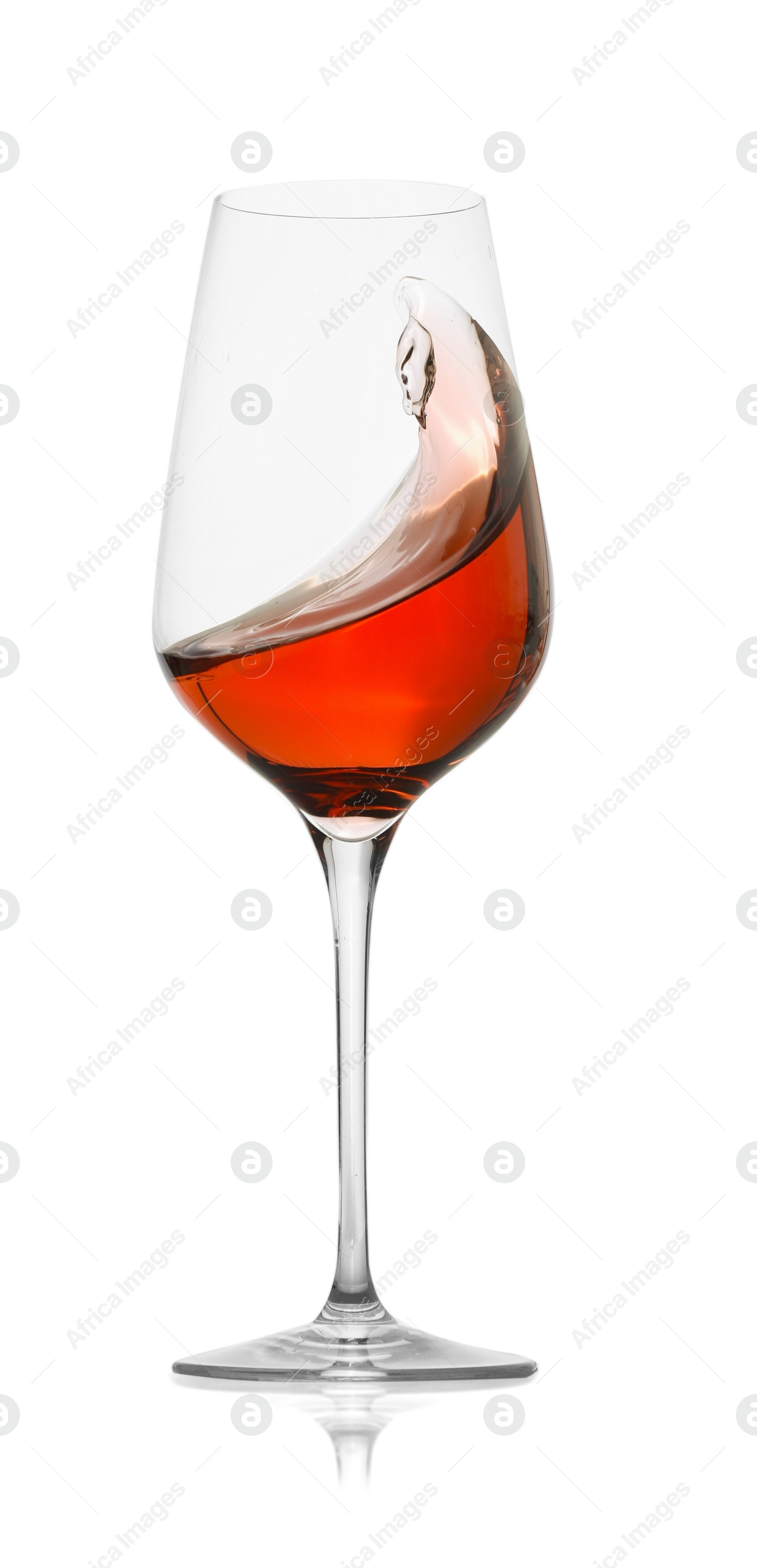 Photo of Rose wine splashing in glass on white background