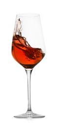 Photo of Rose wine splashing in glass on white background