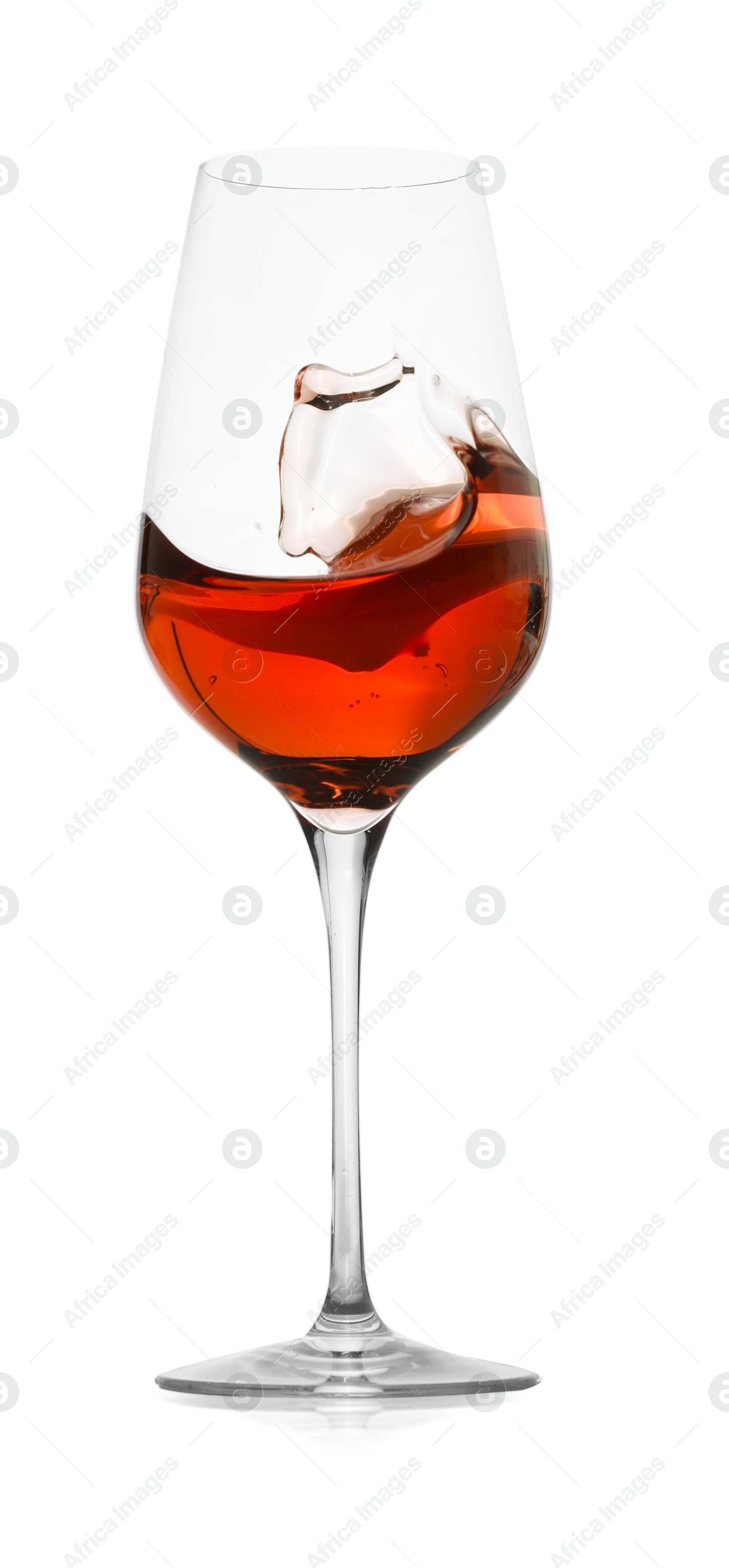 Photo of Rose wine splashing in glass on white background