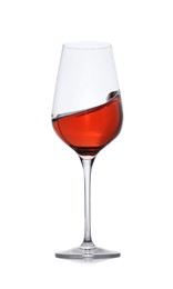 Photo of Rose wine splashing in glass on white background