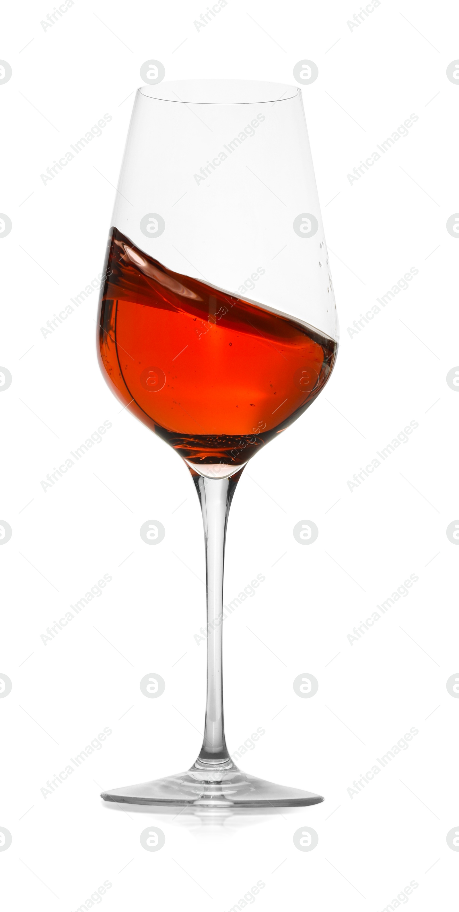 Photo of Rose wine splashing in glass on white background