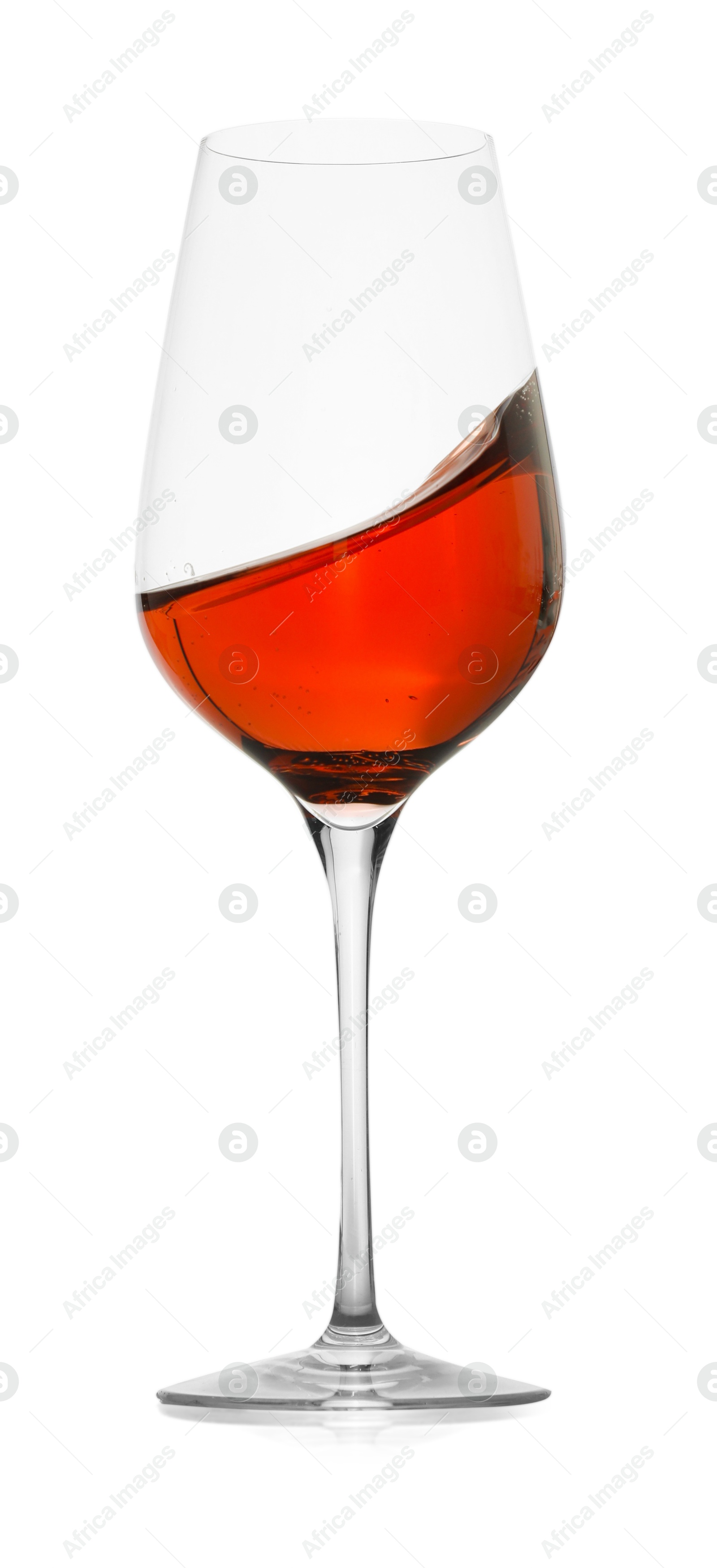 Photo of Rose wine splashing in glass on white background