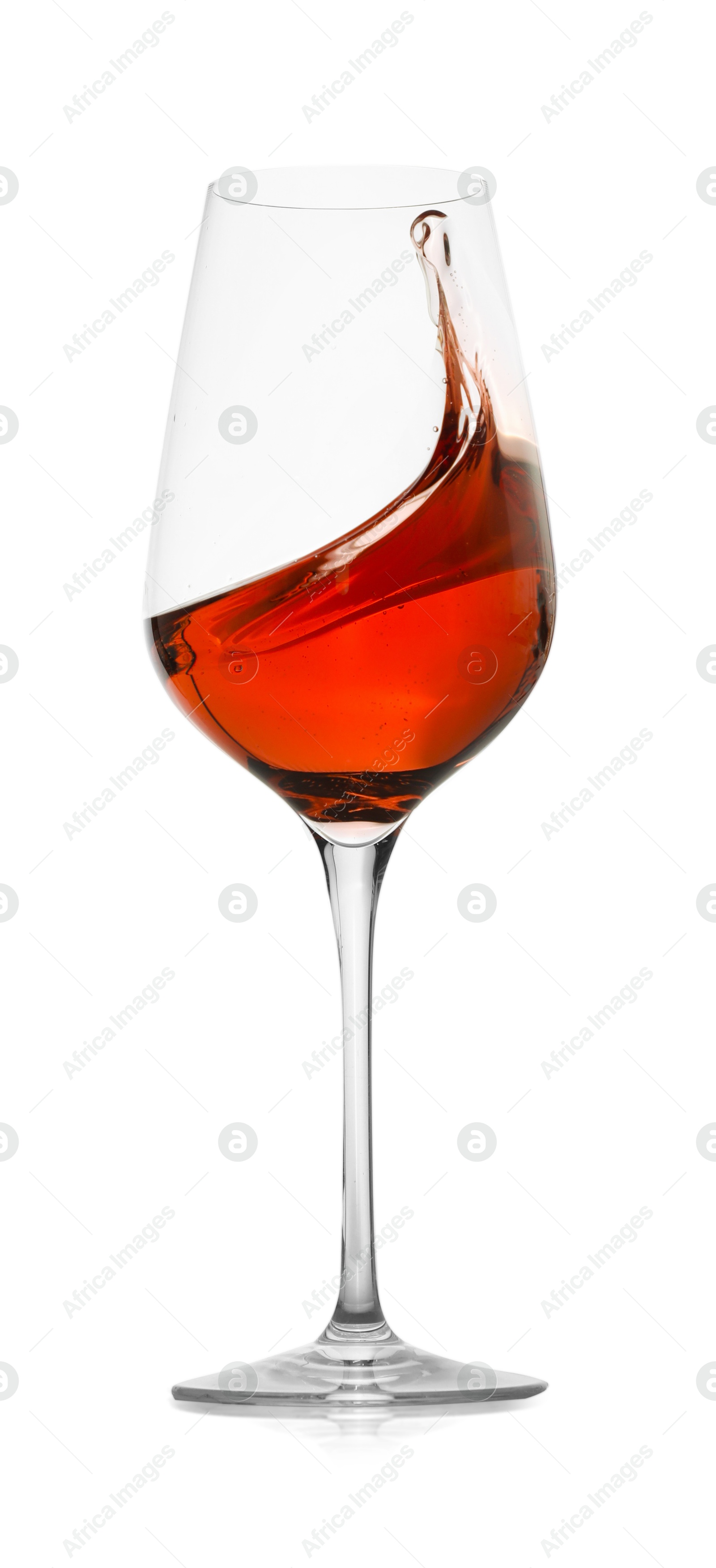 Photo of Rose wine splashing in glass on white background