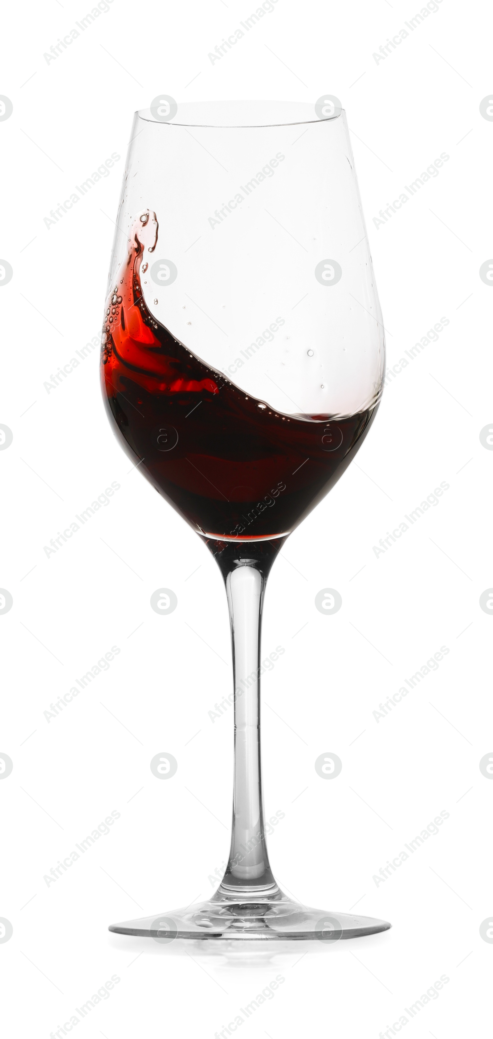 Photo of Red wine splashing in glass on white background