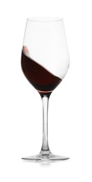 Photo of Red wine splashing in glass on white background