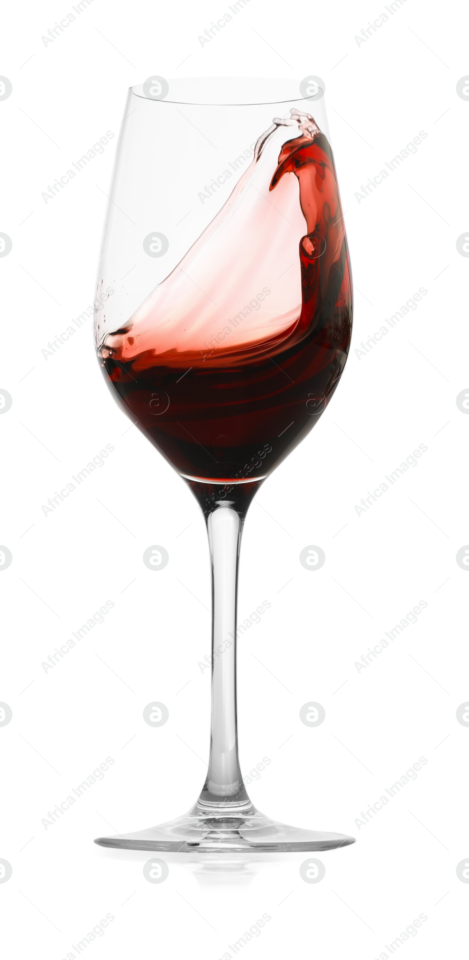 Photo of Red wine splashing in glass on white background