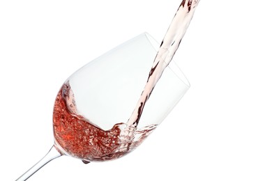 Photo of Pouring rose wine into glass on white background