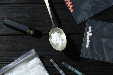 Photo of Flat lay composition with different drugs on black wooden table