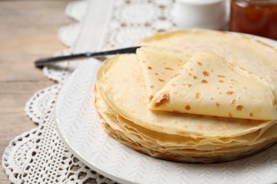 Photo of Stack of delicious crepes on table, closeup