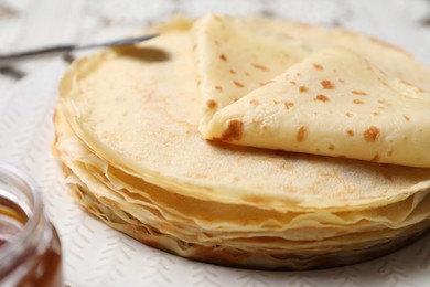 Photo of Stack of delicious crepes on table, closeup