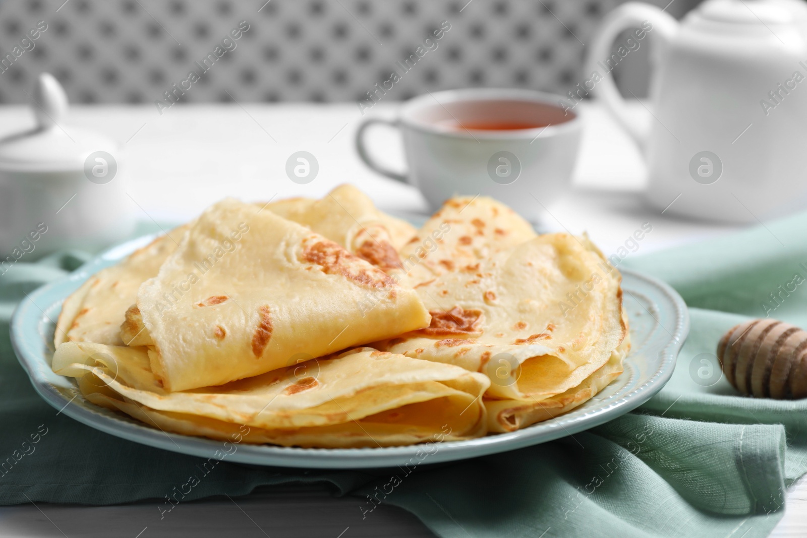 Photo of Delicious crepes served on white table, closeup