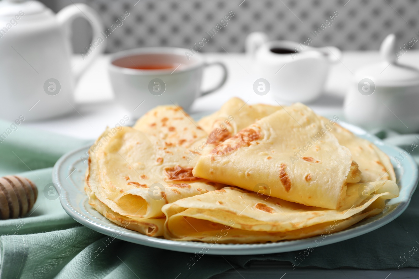 Photo of Delicious crepes served on white table, closeup