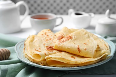 Photo of Delicious crepes served on white table, closeup