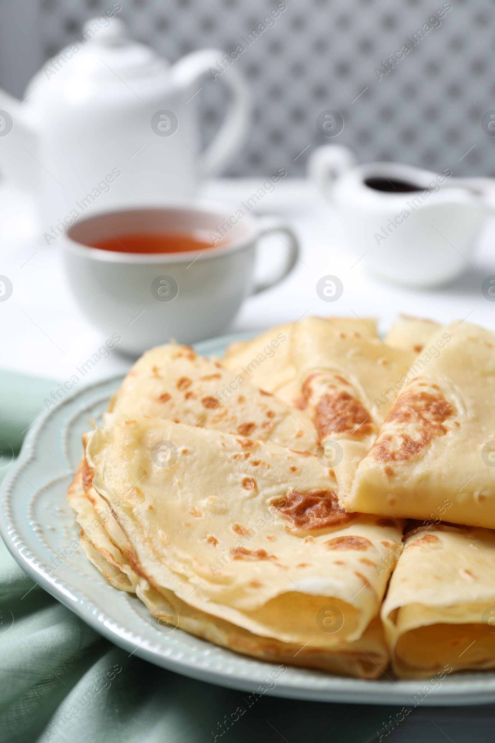 Photo of Delicious crepes served on white table, closeup