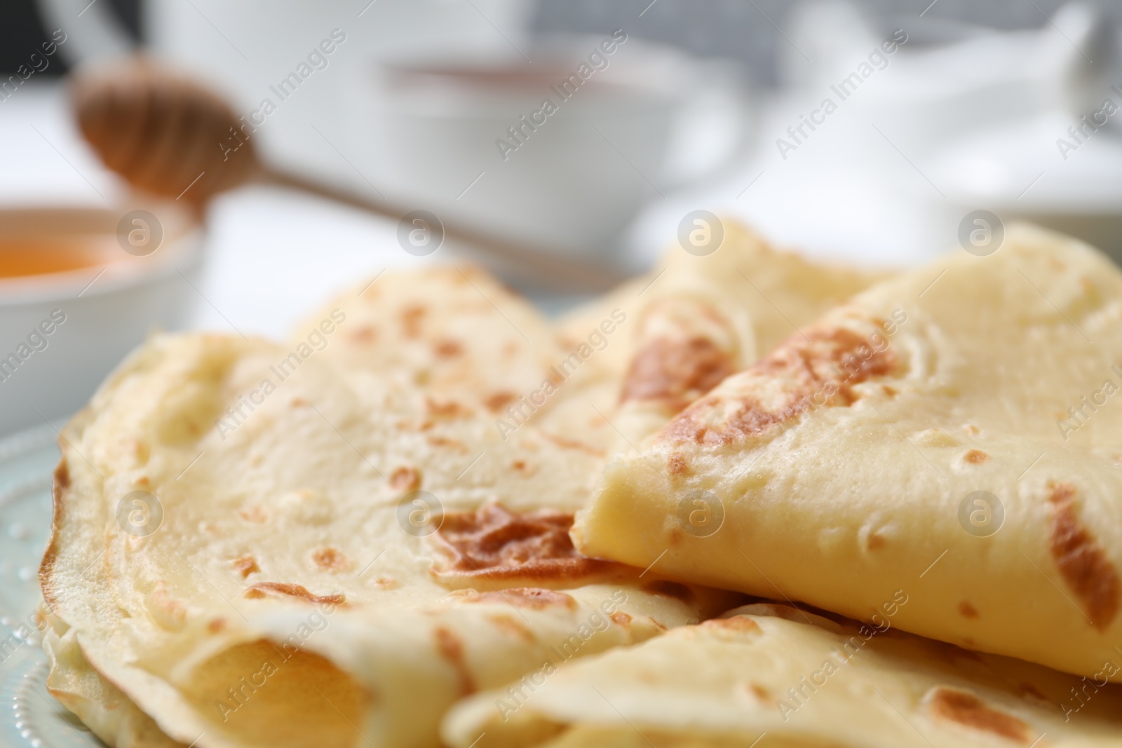 Photo of Delicious folded crepes on table, closeup view