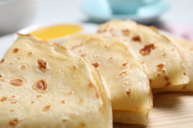 Photo of Delicious folded crepes on table, closeup view