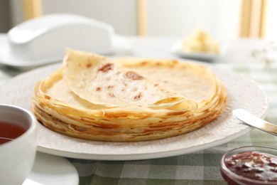 Photo of Stack of delicious crepes on table, closeup