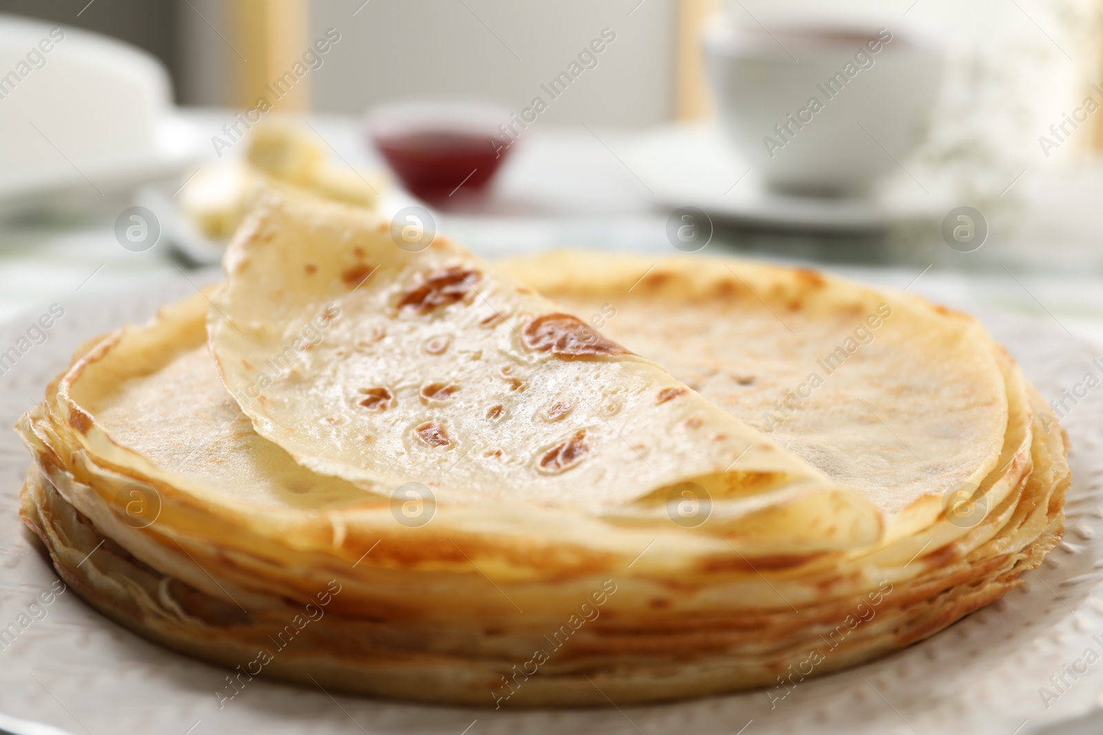 Photo of Stack of delicious crepes on table, closeup