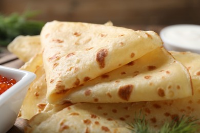 Photo of Delicious crepes on brown table, closeup view