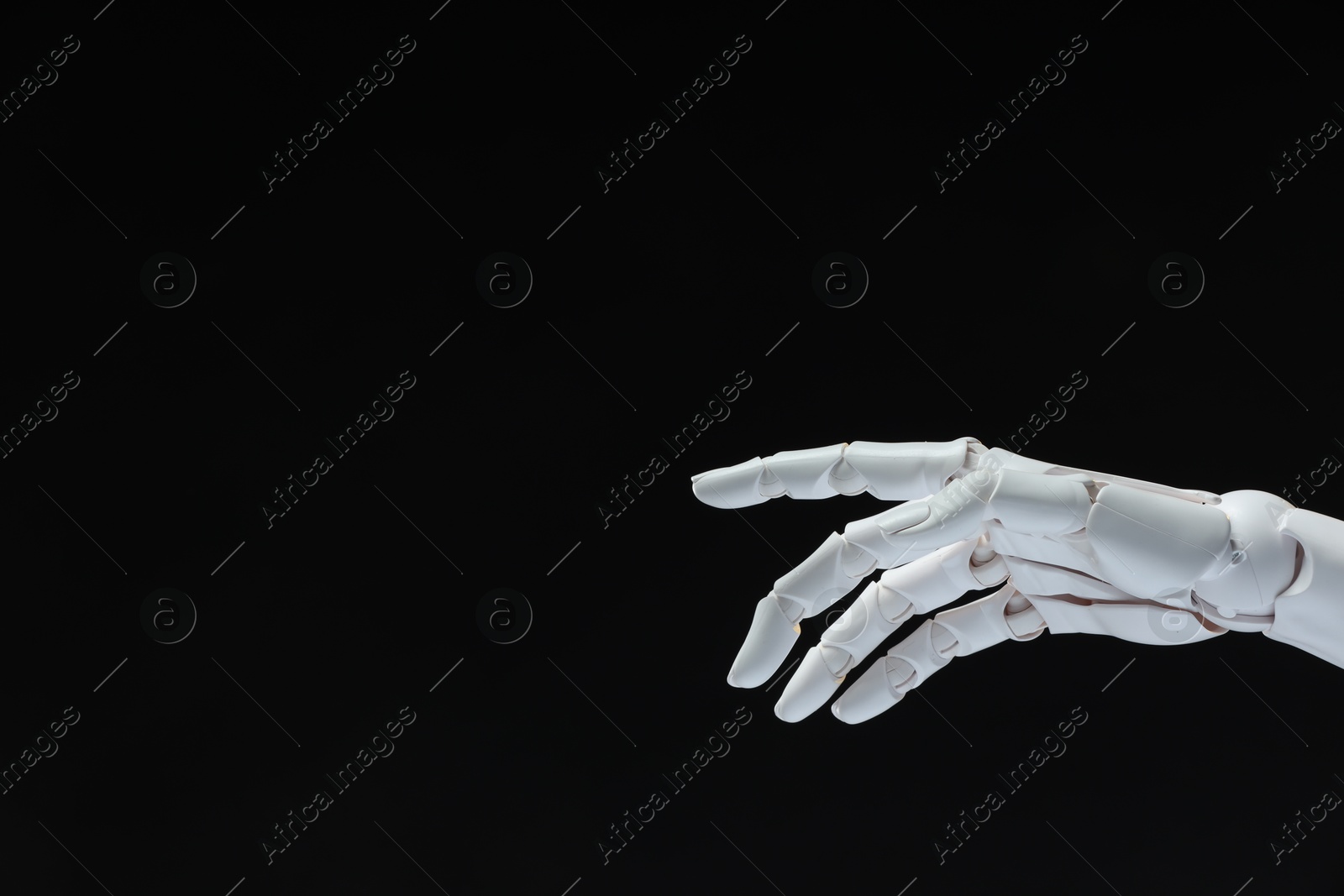 Photo of Artificial intelligence. Robot hand gesturing on black background, space for text