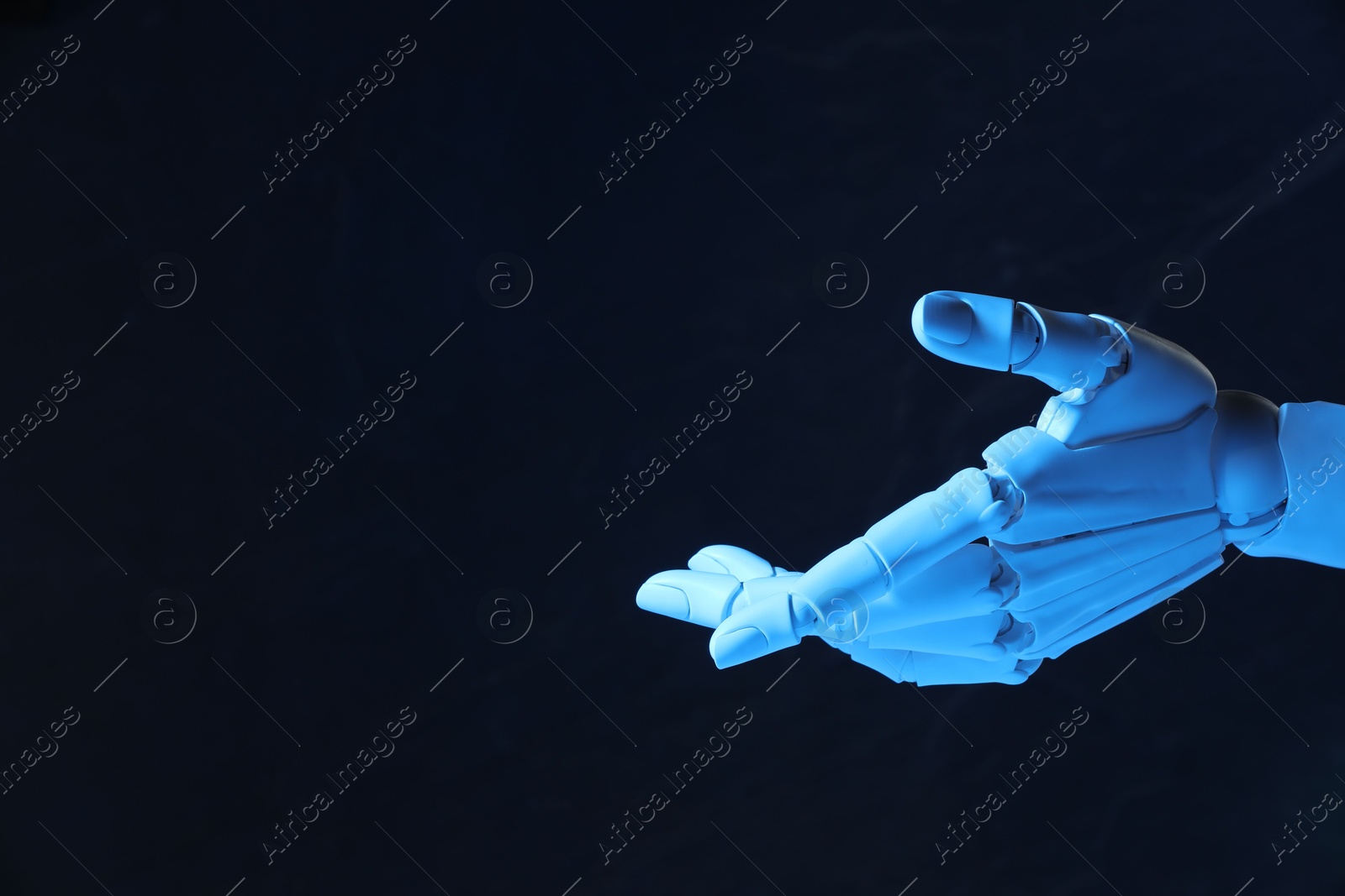 Photo of Artificial intelligence. Robot hand gesturing on dark background, space for text