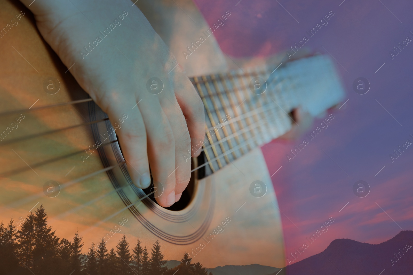 Image of Man playing acoustic guitar, double exposure with beautiful mountain landscape. Inspiring or relaxing power of music