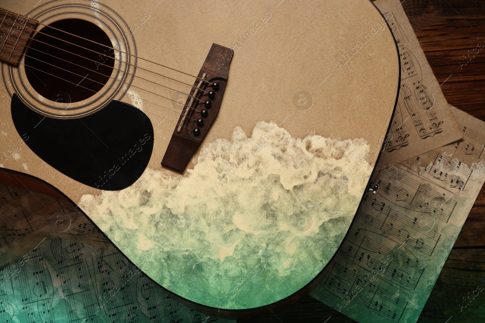 Image of Acoustic guitar, music sheets and rolling on beach waves, double exposure. Inspiring or relaxing power of music