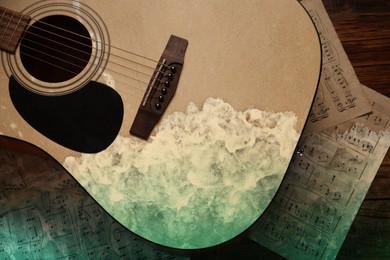 Image of Acoustic guitar, music sheets and rolling on beach waves, double exposure. Inspiring or relaxing power of music