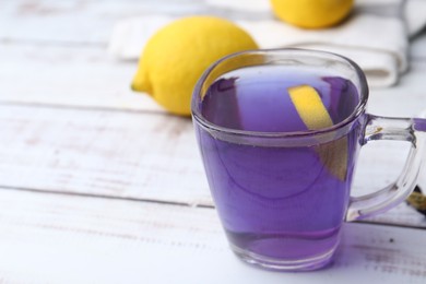 Photo of Delicious butterfly pea flower tea on wooden, closeup. Space for text