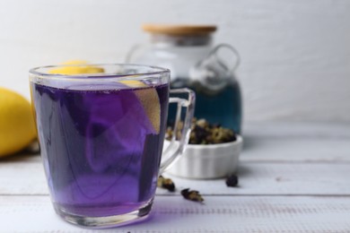 Delicious butterfly pea flower tea on wooden table against white background. Space for text