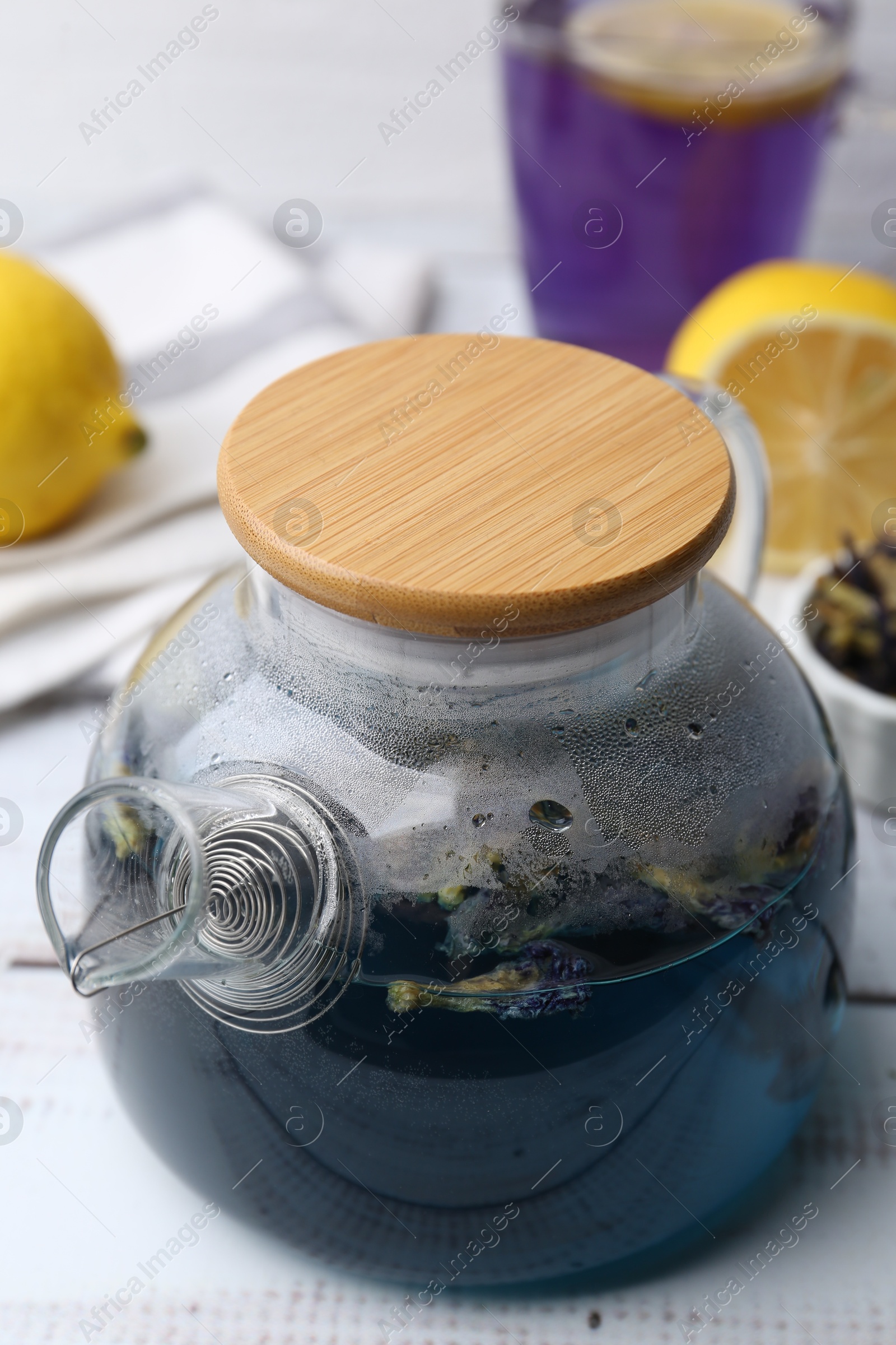 Photo of Delicious butterfly pea flower tea on wooden table, closeup