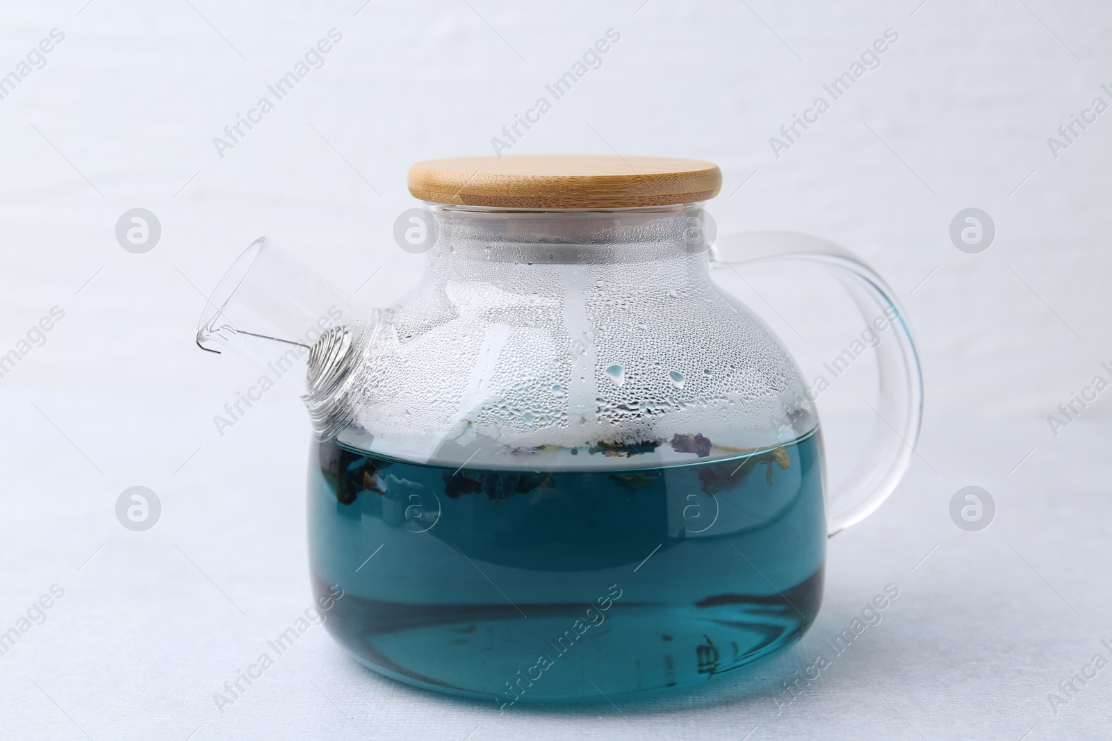 Photo of Delicious butterfly pea flower tea on light table