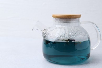 Photo of Delicious butterfly pea flower tea on light table. Space for text